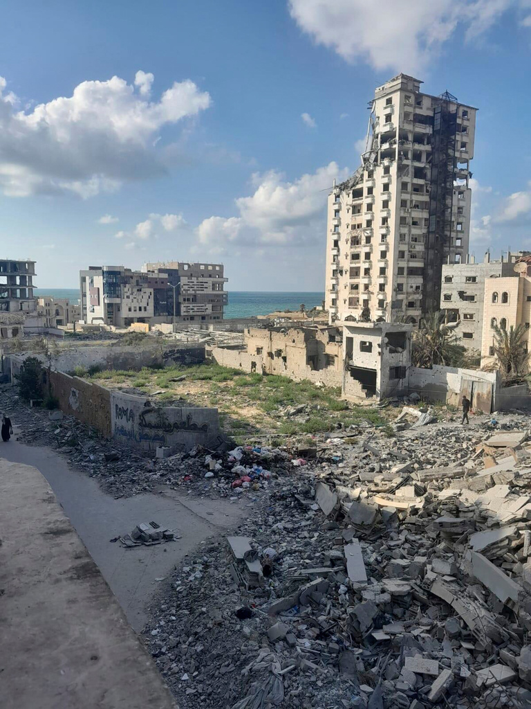 An injured mother stranded in Gaza City as Israeli troops approach, show the destruction outside her parent's home, where she is sheltering with her three daughters in the Gaza Strip. (AP) 